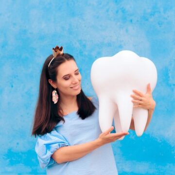 tooth fairy holding tooth